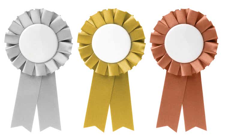 Three ribbon awards in silver, gold, and bronze