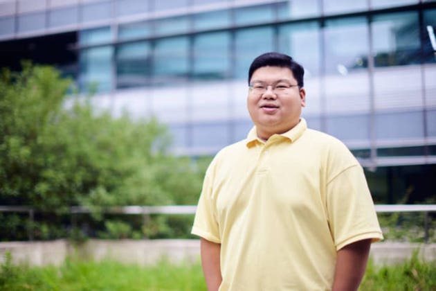 Portrait of fat business Chinese man on rooftop