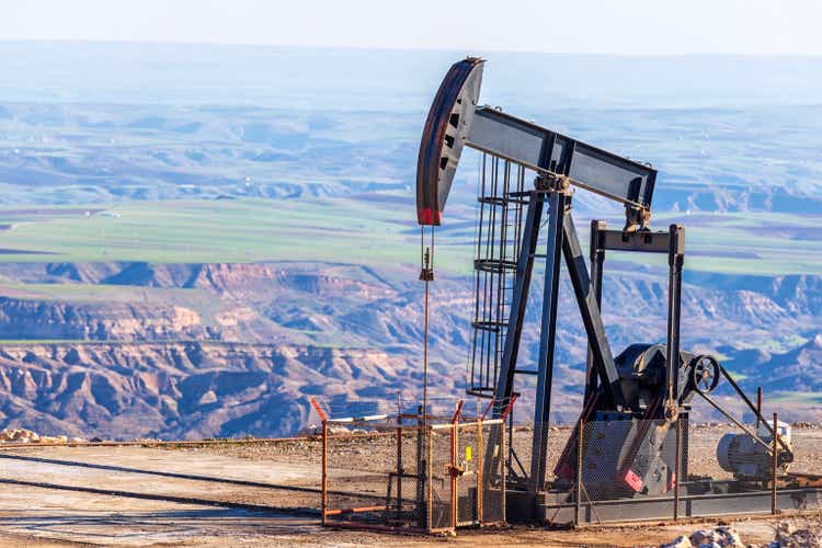 View of the pumpjack in the oil well of the oil field. Arrangement is commonly used for onshore wells producing little oil. It is overground drive for a reciprocating piston pump in an oil well.