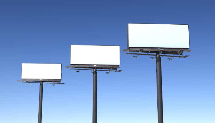 Three billboards isolated against blue sky