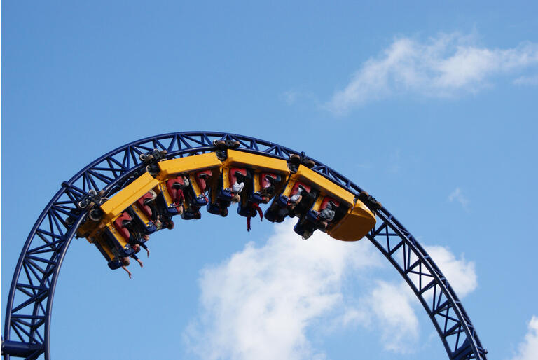 People hanging upside down on the roller coaster track