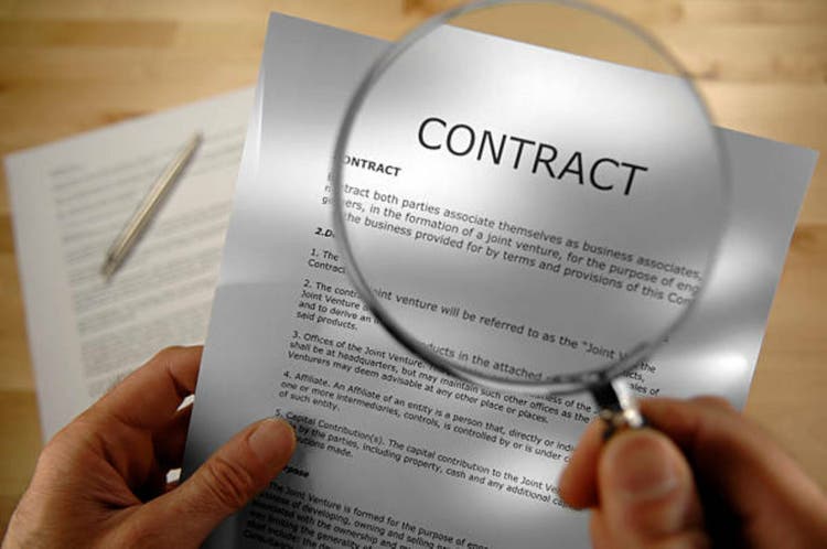 Hands holding magnifier and contract select focus
