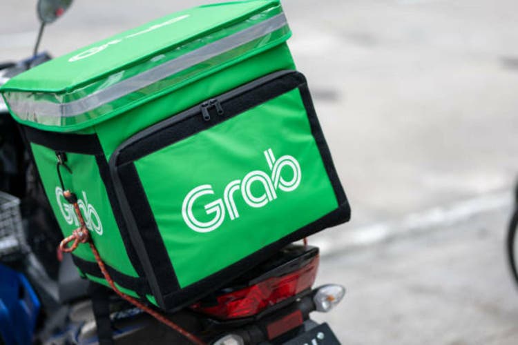 Grab Food motorbike on the street of Kuala Lumpur, Malaysia.