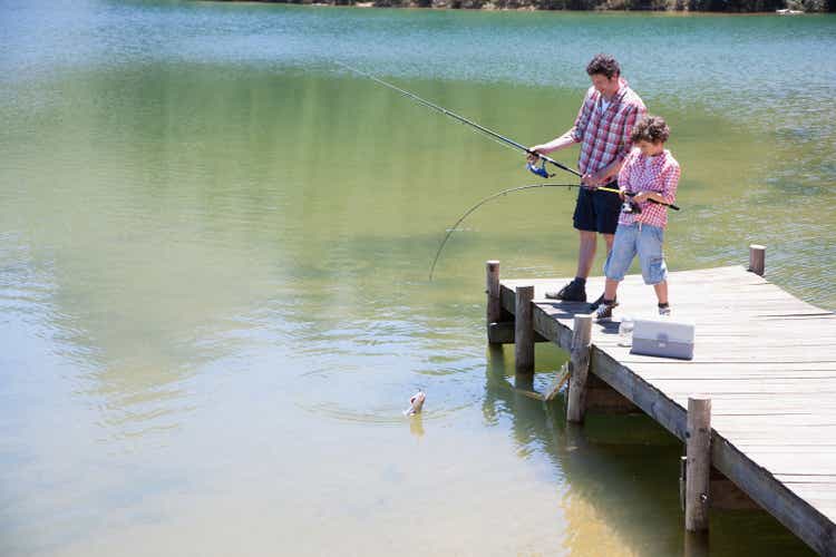 Father and son fishing off dock