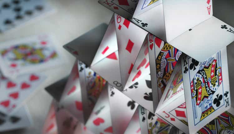 Close-up of a house of cards with spare cards in the back