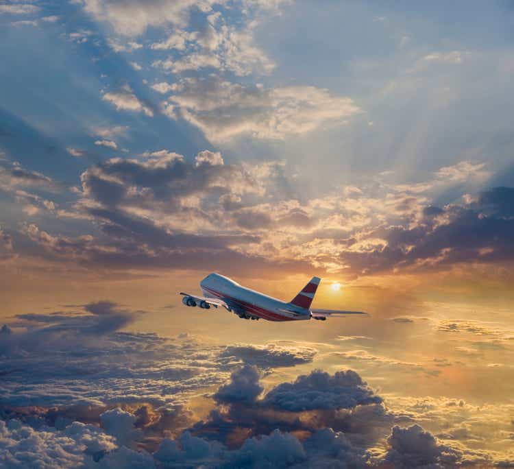 Airplane flying in dramatic sky