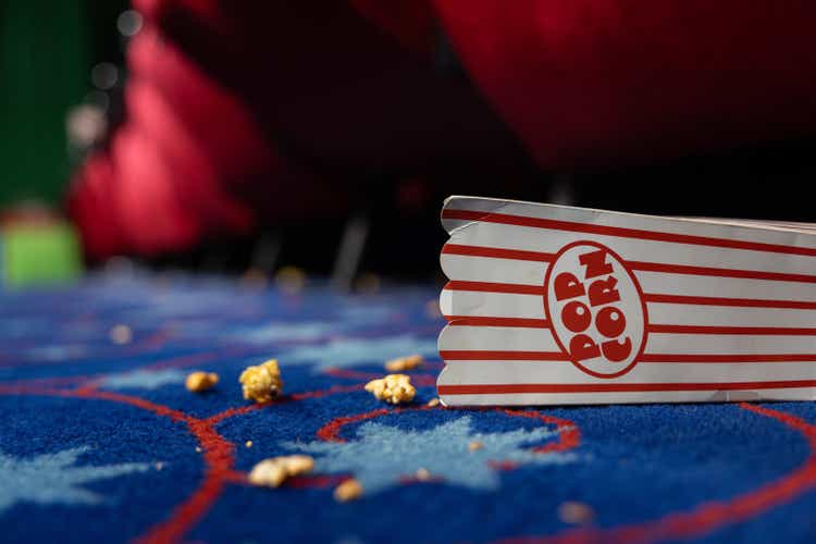 Bucket of popcorn spilled on the movie theater floor