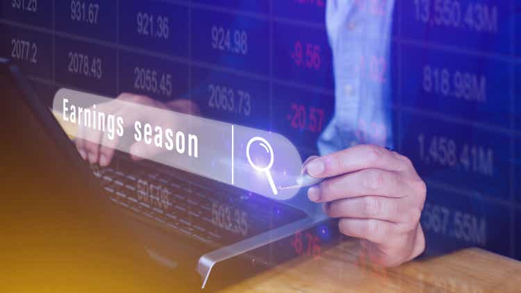 Earnings season Hand touching of written in search bar with the financial data visible in the background, Reports Stock Market Ticker Words