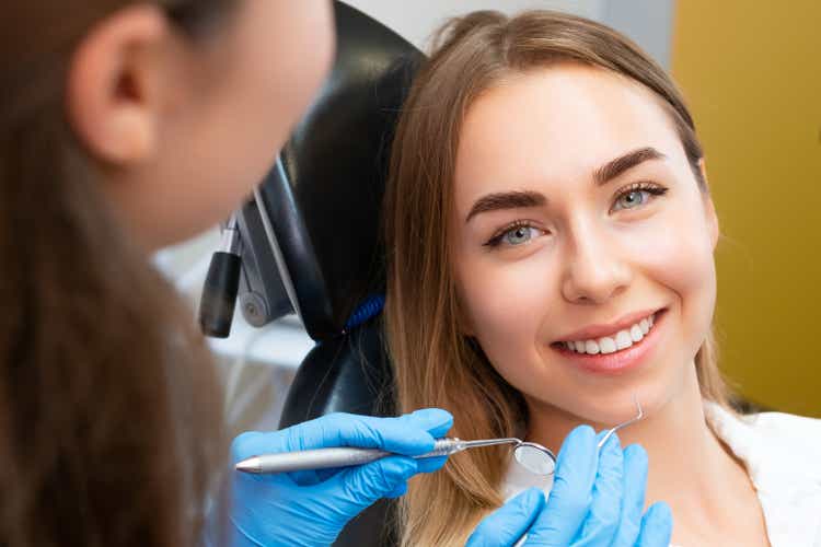 Brown-haired young woman preparing for dental procedure