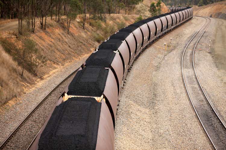 Train loaded with black export coal going around a curve