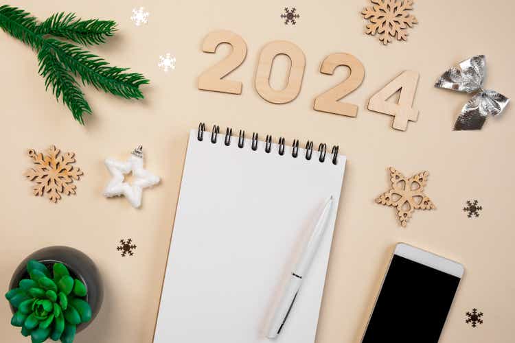 New Year Aims 2024. To Do List. Empty Notebook at the Desk with Holiday Decoration. Top view. Creating Plan, Resolution. New Life, Start Up, Beginning Concept. Business ideas. Goals, action, checklist