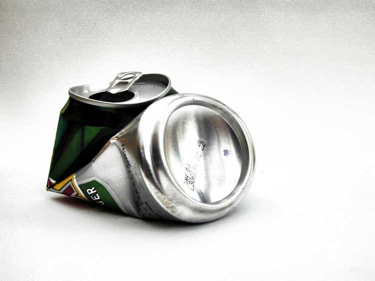 Close-up of crushed aluminum beverage can on white background