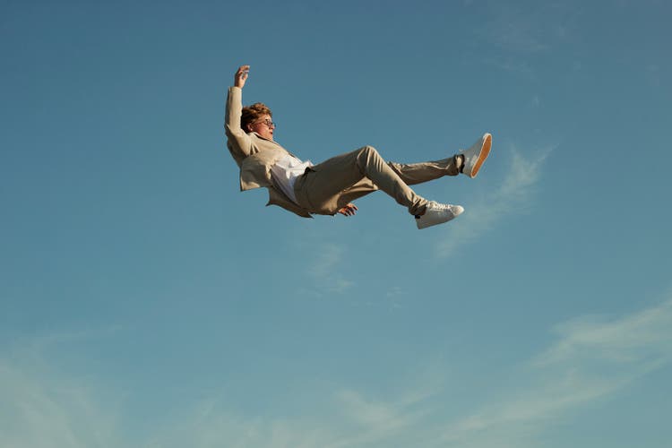 Young man levitating while doing acrobats