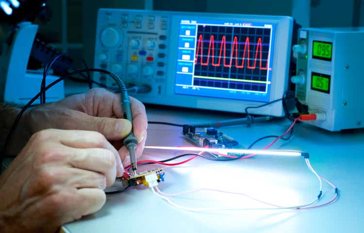 Scientific hands experimenting with monitors and electrodes