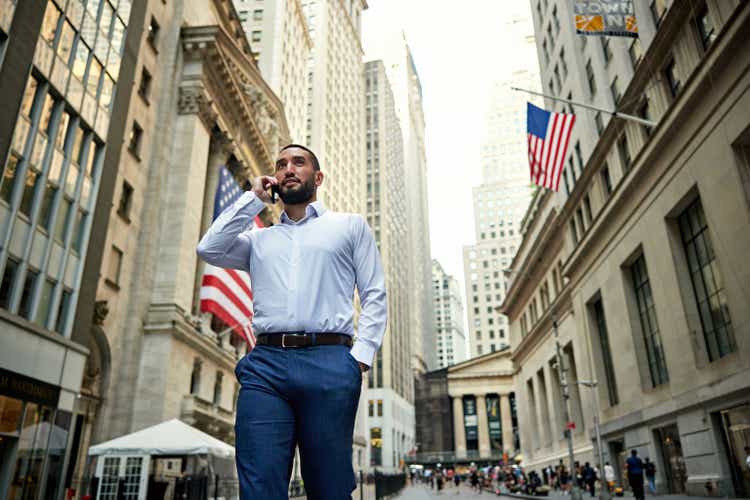 Wall Street trader using phone outdoors