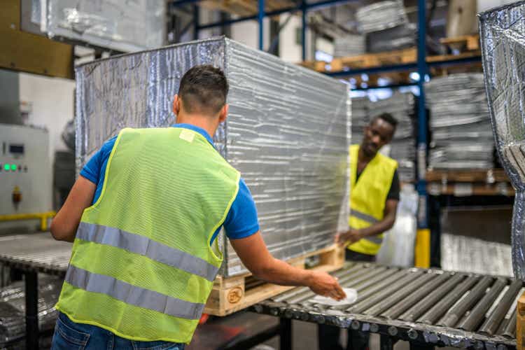 Diverse Airport Warehouse Workers Preparing Parcel For Aircraft Shipping