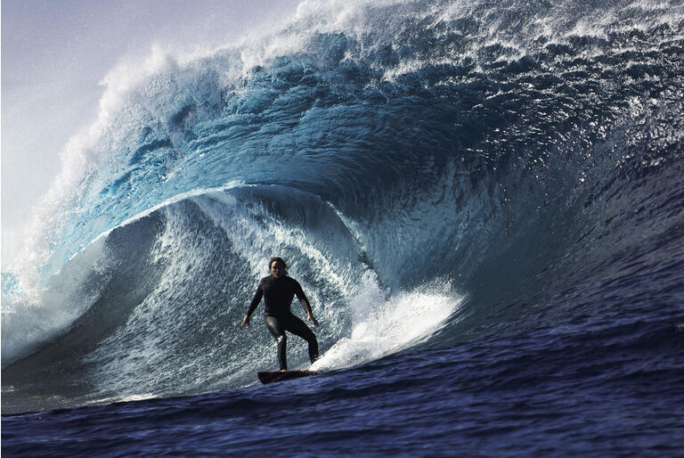 Large wave with surfer in tunnel wave