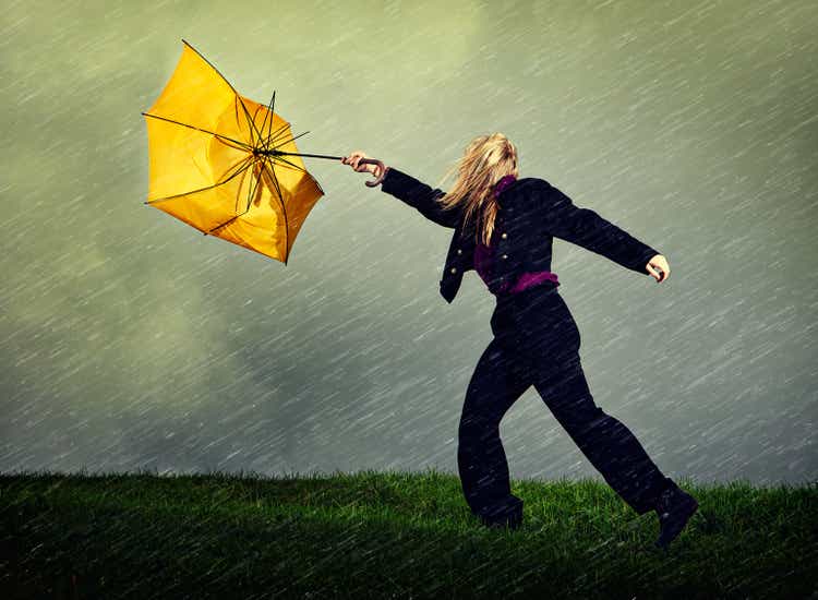 Wet, windy, winter weather blows woman and umbrella away