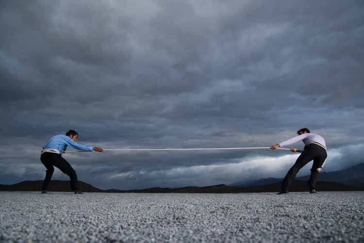 Two men outdoors in tug of war