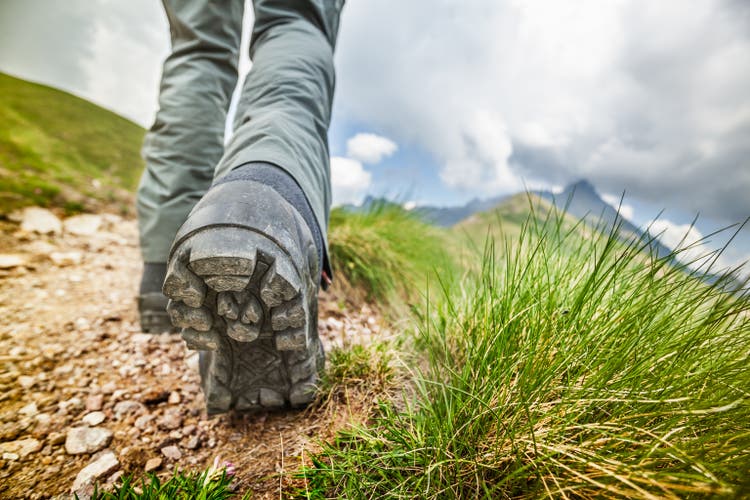 Hiker goes on mountain trail