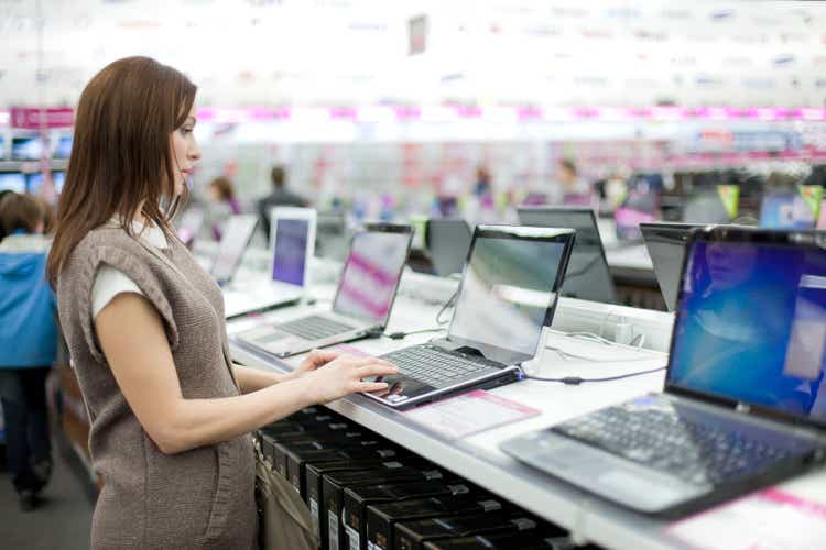 woman chooses the laptop