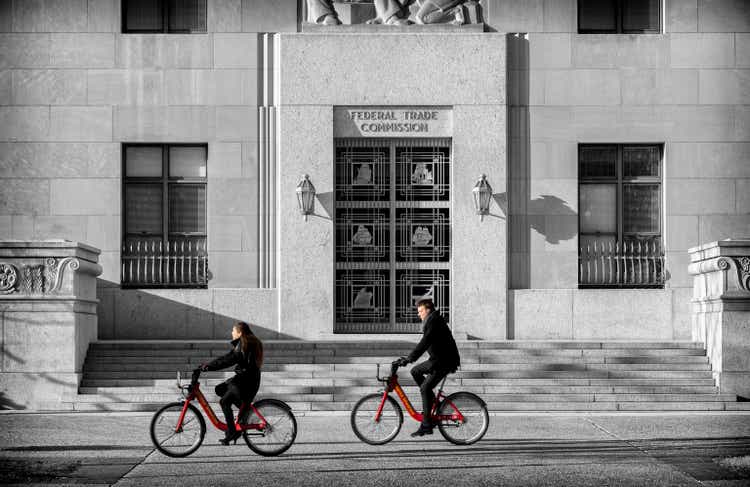 Two bicyclists, using bicycles from a bike sharing system, ride past the Art Deco Federal Trade Commission (<a href='https://seekingalpha.com/symbol/FTC' title='First Trust Large Cap Growth AlphaDEX ETF'>FTC</a>) building in Washington DC