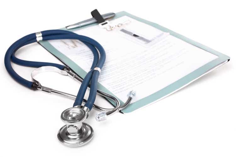 Stethoscope and a report isolated over white