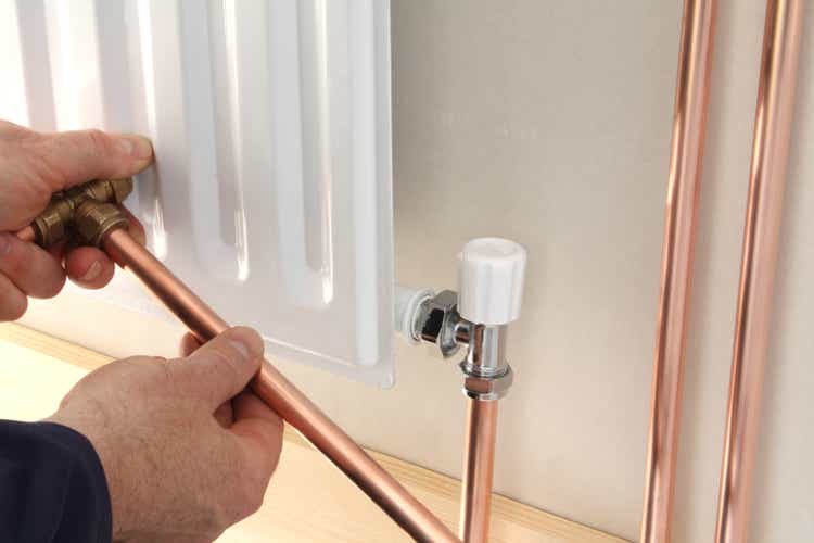 A plumber installing a new radiator