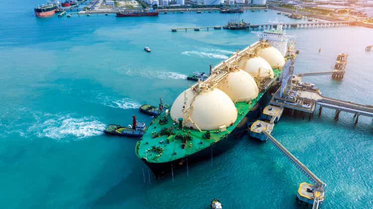 LNG (Liquefied natural gas) tanker anchored in Gas terminal gas tanks for storage. Oil Crude Gas Tanker Ship. LPG at Tanker Bay Petroleum Chemical or Methane freighter export import transportation