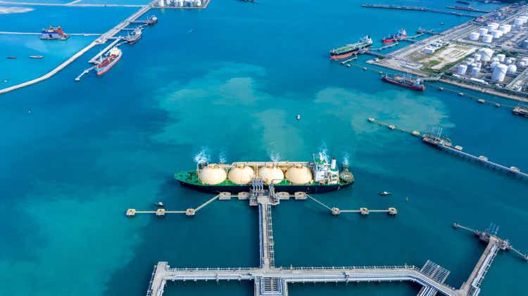 LNG (Liquefied natural gas) tanker anchored in Gas terminal gas tanks for storage. Oil Crude Gas Tanker Ship. LPG at Tanker Bay Petroleum Chemical or Methane freighter export import transportation