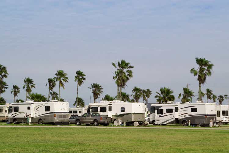 An RV park with the same RVs all in a row