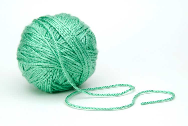 green ball of yarn on white background