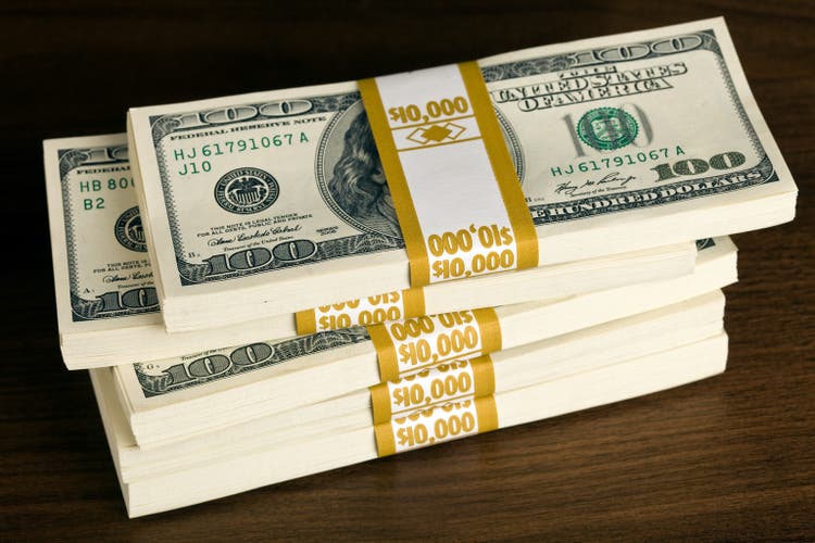 $50,000 in US $100 Bills on a Walnut Desk