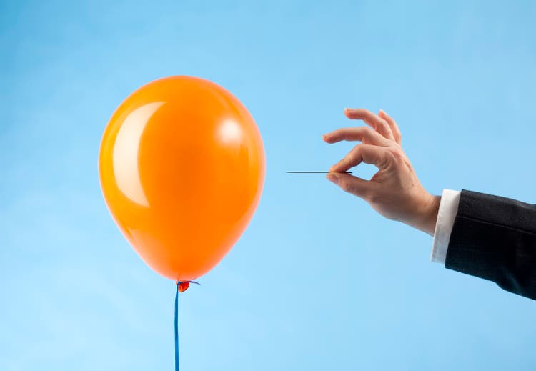 Balloon attacked by hand with needle