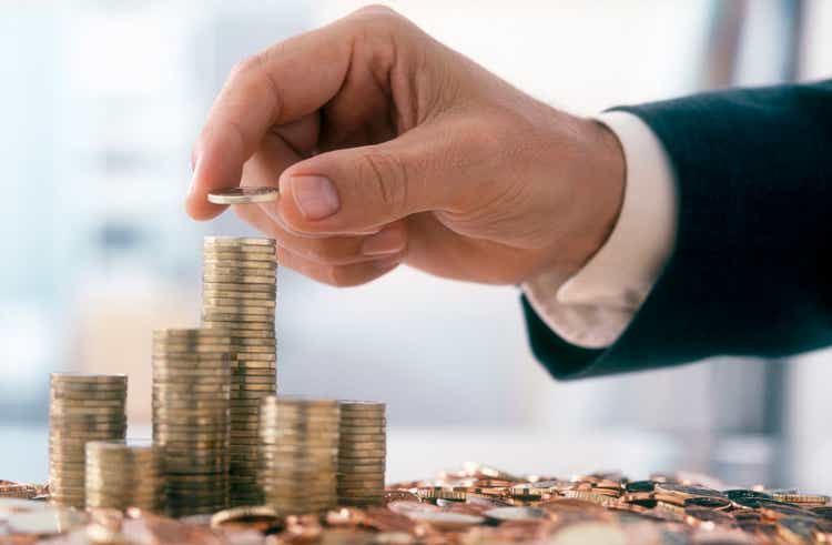 Businessman is stacking coins