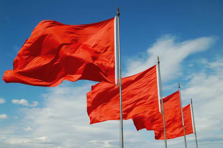 A row of red flags blowing in the wind