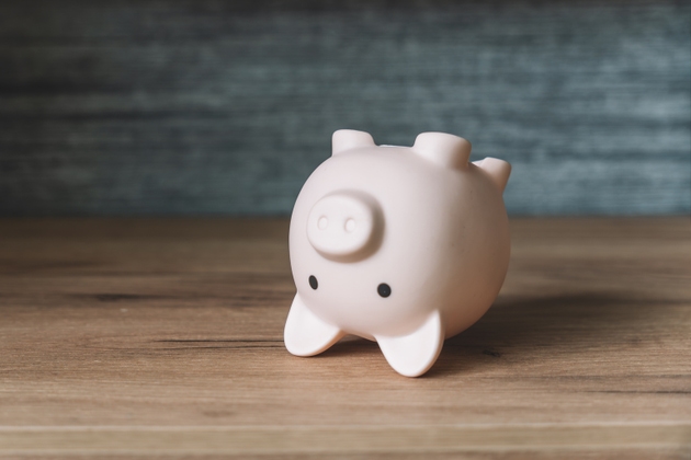 Pink piggy bank upside down. lack of money, concept of poverty and poverty is a crisis in savings.