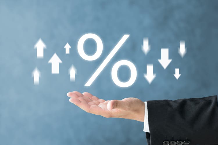 Business man"s hand and percentage sign with upward and downward arrows
