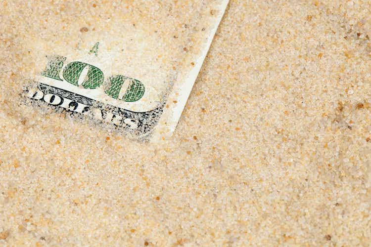 $100 Bill within Frac Sand