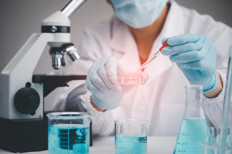 Medical Development Laboratory, biochemical research scientist Asian Doctor working with a microscope for vaccine development in the pharmaceutical research laboratory, Biotechnology Specialist