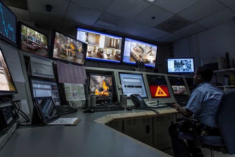 African American security officer working in control room