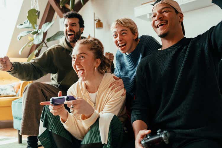 Group of friends playing video games on a console