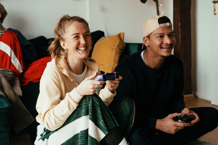 Young couple playing video games on a console