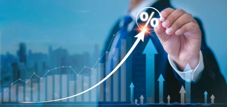 Businessman uses circle pen to calculate percentage of income and investment profit and add positive growth indicator with virtual hologram graph. Compensation fund. Investment. Dividend tax.