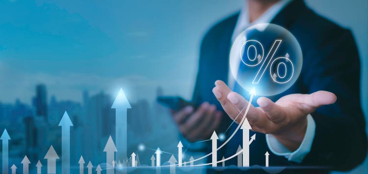Financial business growth concept The businessman has chosen a percentage, calculated income and investment profits and added positive growth indicators with a virtual holographic graph.