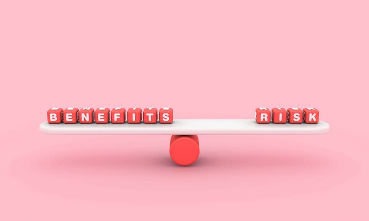 Seesaw with BENEFITS RISK Buzzword Cubes