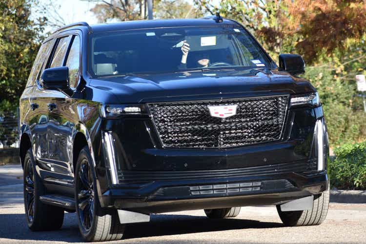 A portrait of a black Cadillac Escalade cruising near Allen Parkway Houston TX