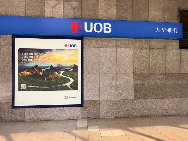 Advertisement and sign on a wall for UOB, United Overseas Bank, a leading bank and financial services company in Singapore.