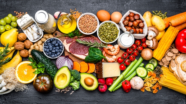 Composition healthy food arranged in a row on dark background