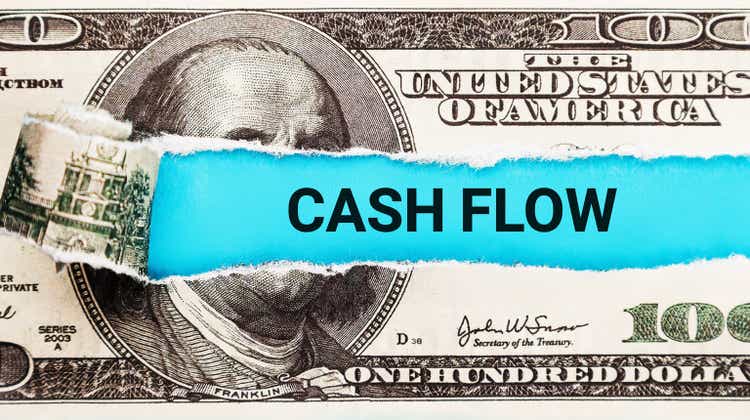 Cash Flow Finance. The word Cash Flow in the background of the US dollar. Money Flowing through a Business Pipeline. Financial Income, Budgeting, and Cash Management Concept.